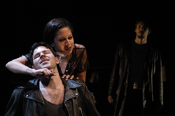 Eurydice (Regina Aquino) threatens Orpheus (Jason McCool) while Zeus/G. (Anthony Gallagher) watches.